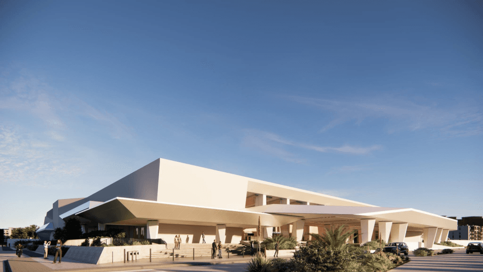 Davcon Maa convention center exterior, three-peak roofline with palm trees